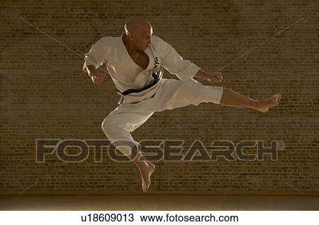 Karate man kicking. View Large Photo Image Stock Image - Karate man kicking.. Fotosearch