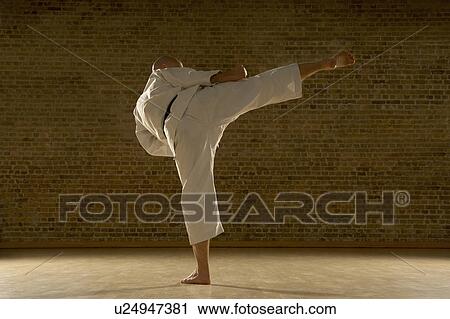Karate man kicking. View Large Photo Image Stock Image - Karate man kicking.. Fotosearch