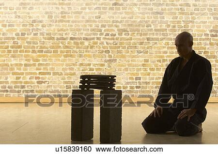 Stock Image - Karate man kneeling.. Fotosearch
