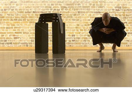 Picture - Karate man squatting.. Fotosearch