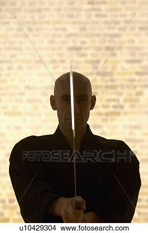 Karate man with Samurai sword. View Large Photo Image Picture - Karate man with Samurai sword.. Fotosearch