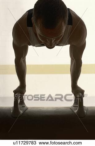 Male gymnast balancing on pommel horse View Large Photo Image Stock Image - Male gymnast balancing on pommel horse. Fotosearch