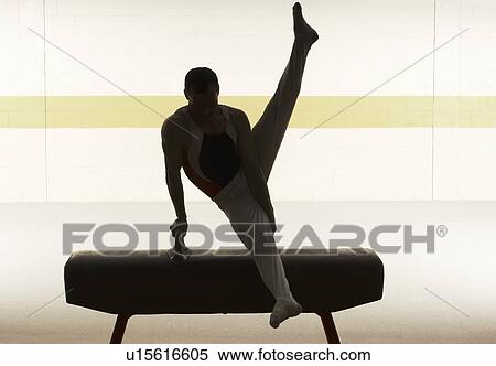 Stock Photography - Male gymnast performing on pommel horse. Fotosearch