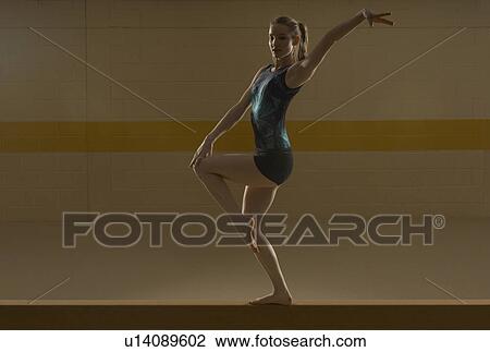 Teenage (16-18) gymnast performing on balance bar View Large Photo Image Stock Image - Teenage (16-18) gymnast performing on balance bar. Fotosearch