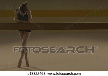 Teenage gymnast (16-18) leaning on balance beam View Large Photo Image Stock Photo - Teenage gymnast (16-18) leaning on balance beam. Fotosearch