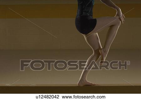 Teenage gymnast (16-18) performing on balance beam View Large Photo Image Stock Image - Teenage gymnast (16-18) performing on balance beam. Fotosearch