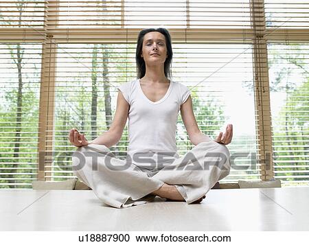 Woman on table top in front of windows doing yoga. View Large Photo Image Stock Image - Woman on table top in front of windows doing yoga.. Fotosearch