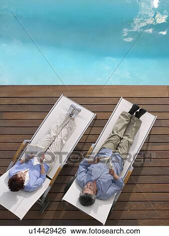 Stock Photograph - Mature couple relaxing. Fotosearch