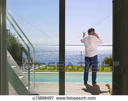 Mature man on the mobile outdoors View Large Photo Image Stock Photo - Mature man on the mobile outdoors . Fotosearch