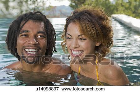 Young man and woman in a pool View Large Photo Image Stock Photo - Young man and woman in a pool. Fotosearch