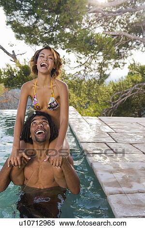 Young man and woman in a pool View Large Photo Image Stock Photography - Young man and woman in a pool. Fotosearch