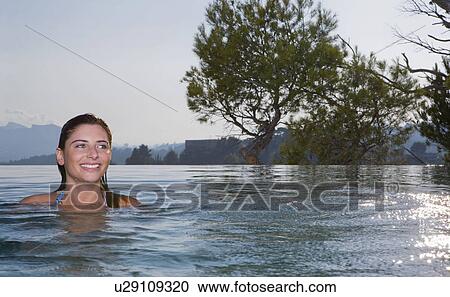 Young woman in a pool View Large Photo Image Stock Image - Young woman in a pool. Fotosearch