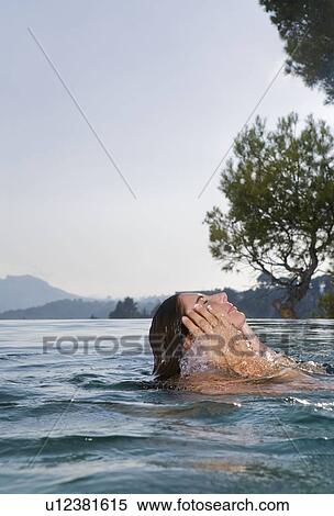 Young woman in a pool View Large Photo Image Stock Photography - Young woman in a pool. Fotosearch