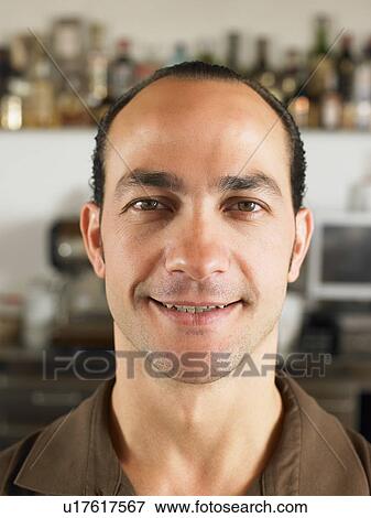 Bartender smiling in front of bar. View Large Photo Image Stock Photo - Bartender smiling in front of bar.. Fotosearch