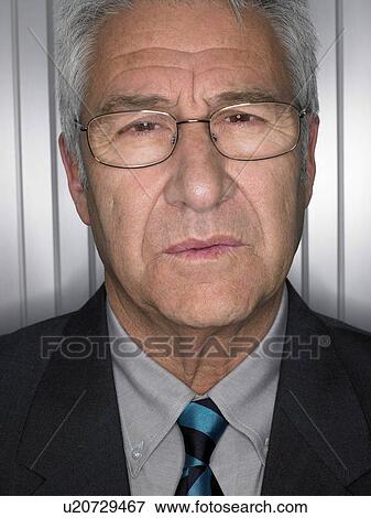 Businessman in front of a silver wall. View Large Photo Image Stock Photo - Businessman in front of a silver wall.. Fotosearch