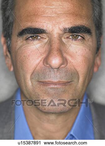 Stock Image - Close up portrait of older man's face, serious expression, Alicante, Spain,. Fotosearch