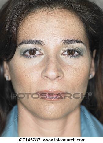 Stock Photo - Close up portrait of woman's face, serious expression, Alicante, Spain,. Fotosearch