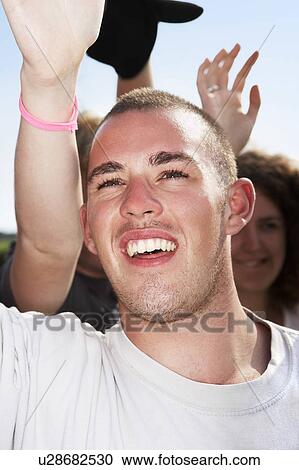 Stock Image - Male in crowd cheering. Fotosearch