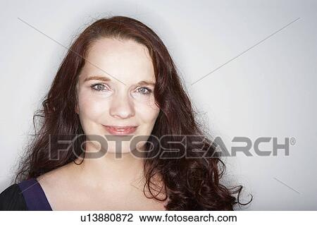 Stock Image - Woman looking at camera smiling.. Fotosearch
