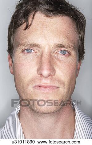 Stock Image - Young man looking at camera.. Fotosearch