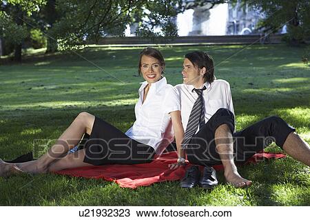 Businessman and woman sitting on blanket in meadow in park both bare feet. View Large Photo Image Stock Image - Businessman and woman sitting on blanket in meadow in park both bare feet.. Fotosearch