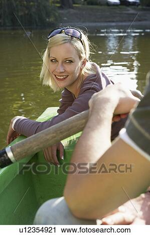 Couple in a rowboat smiling. View Large Photo Image Stock Image - Couple in a rowboat smiling.. Fotosearch