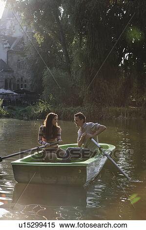 Couple in a rowboat smiling. View Large Photo Image Stock Photography - Couple in a rowboat smiling.. Fotosearch