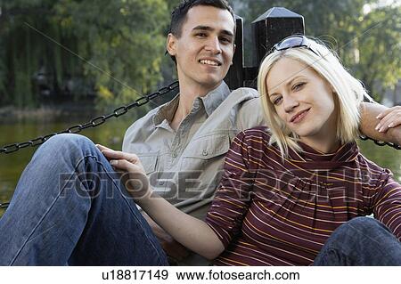 Couple on a dock smiling and relaxing. View Large Photo Image Stock Photo - Couple on a dock smiling and relaxing.. Fotosearch