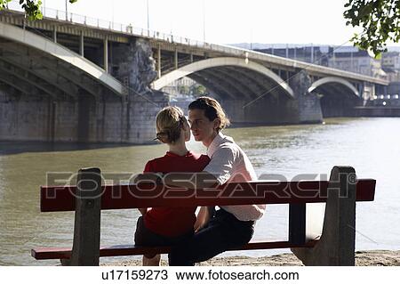 Couple on bench by River. View Large Photo Image Stock Image - Couple on bench by River.. Fotosearch