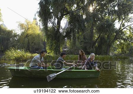 Four friends in a rowboat smiling. View Large Photo Image Stock Image - Four friends in a rowboat smiling.. Fotosearch