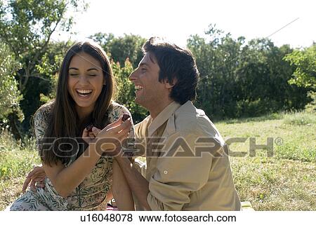 Young couple sharing fresh fruit View Large Photo Image Stock Photo - Young couple sharing fresh fruit. Fotosearch