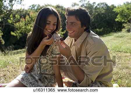 Young couple sharing fresh fruit View Large Photo Image Stock Photography - Young couple sharing fresh fruit . Fotosearch