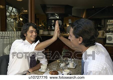 Businessmen giving a high five to each other. View Large Photo Image Stock Photograph - Businessmen giving a high five to each other.. Fotosearch