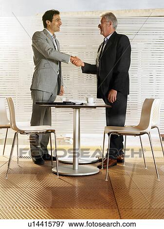 Stock Photo - Businessmen in a restaurant.. Fotosearch
