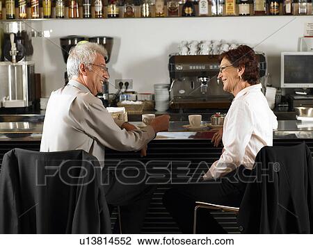 Businesspeople at a bar drinking coffee. View Large Photo Image Stock Image - Businesspeople at a bar drinking coffee.. Fotosearch