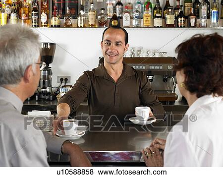 Businesspeople at a bar drinking coffee. View Large Photo Image Stock Photo - Businesspeople at a bar drinking coffee.. Fotosearch