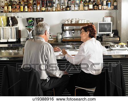 Businesspeople at a bar drinking coffee. View Large Photo Image Stock Photograph - Businesspeople at a bar drinking coffee.. Fotosearch