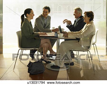 Businesspeople in a restaurant. View Large Photo Image Picture - Businesspeople in a restaurant.. Fotosearch