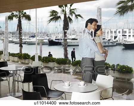 Couple being affectionate in a restaurant. View Large Photo Image Stock Image - Couple being affectionate in a restaurant.. Fotosearch