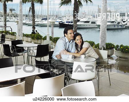 Couple being affectionate in a restaurant. View Large Photo Image Stock Image - Couple being affectionate in a restaurant.. Fotosearch