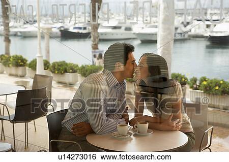 Stock Photograph - Couple being affectionate in a restaurant.. Fotosearch