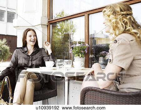 Two women at an outdoor restaurant View Large Photo Image Stock Image - Two women at an outdoor restaurant. Fotosearch