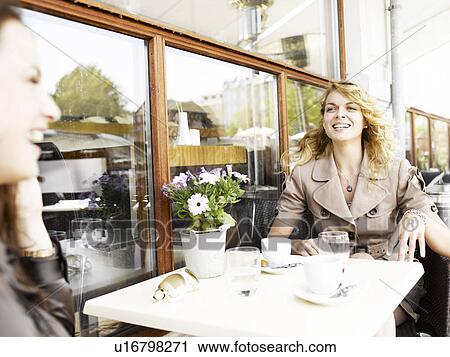 Two women at an outdoor restaurant View Large Photo Image Stock Image - Two women at an outdoor restaurant. Fotosearch