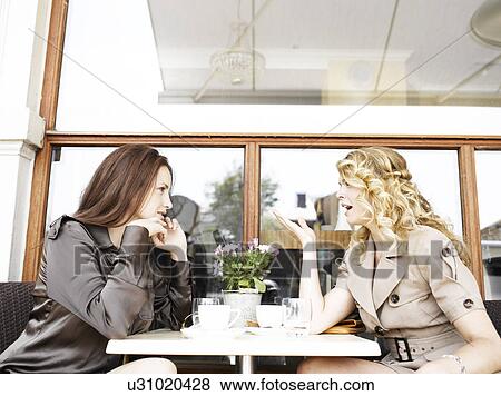 Stock Photo - Two women at an outdoor restaurant. Fotosearch