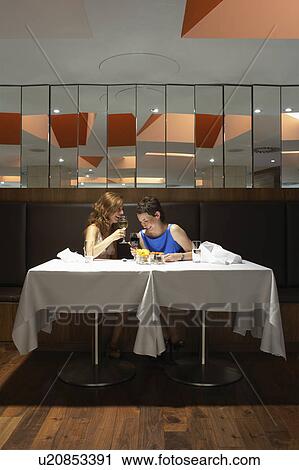 Two women laughing and drinking wine View Large Photo Image Stock Image - Two women laughing and drinking wine. Fotosearch
