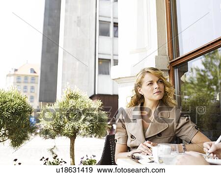 Woman at an outdoor restaurant View Large Photo Image Stock Photo - Woman at an outdoor restaurant. Fotosearch
