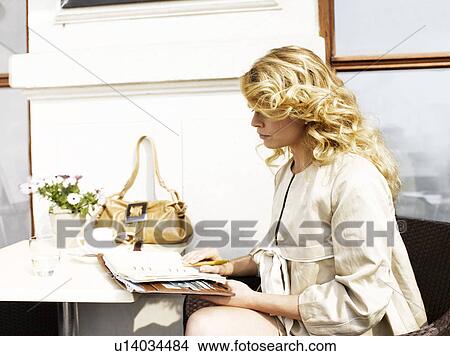 Woman at an outdoor restaurant with her day planner View Large Photo Image Picture - Woman at an outdoor restaurant with her day planner. Fotosearch