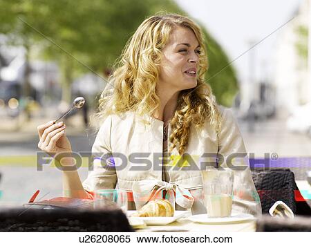 Woman eating at an outdoor restaurant View Large Photo Image Stock Photography - Woman eating at an outdoor restaurant. Fotosearch