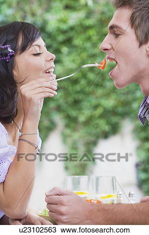 Woman feeding man piece of tomato. View Large Photo Image Stock Image - Woman feeding man piece of tomato.. Fotosearch