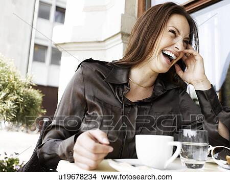 Woman laughing at an outdoor restaurant View Large Photo Image Picture - Woman laughing at an outdoor restaurant. Fotosearch